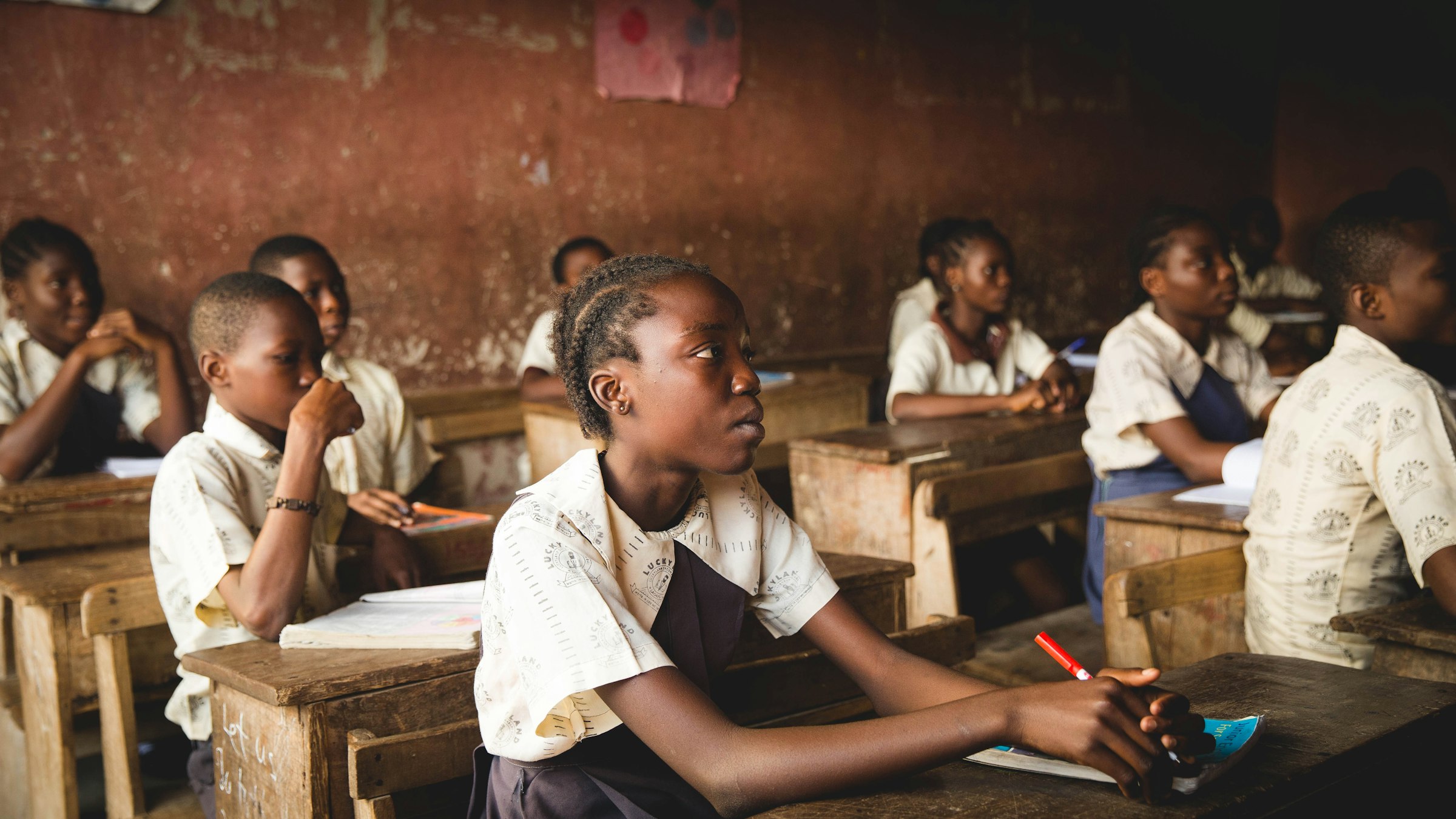 Schoolgirl in uniform attentive at her desk in a classroom in Lagos, Nigeria