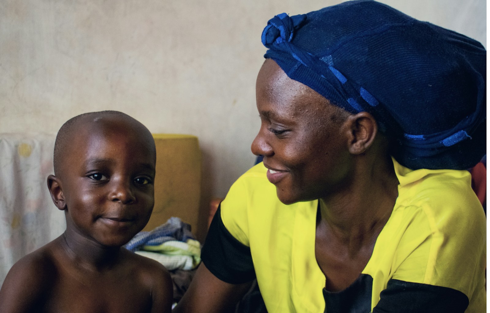 A caregiver sitting with a child at home, a warm intimate moment