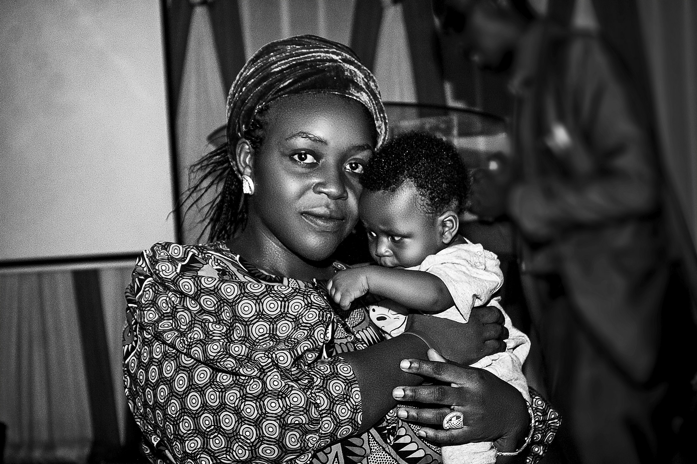 Tender close portrait of a woman holding an infant