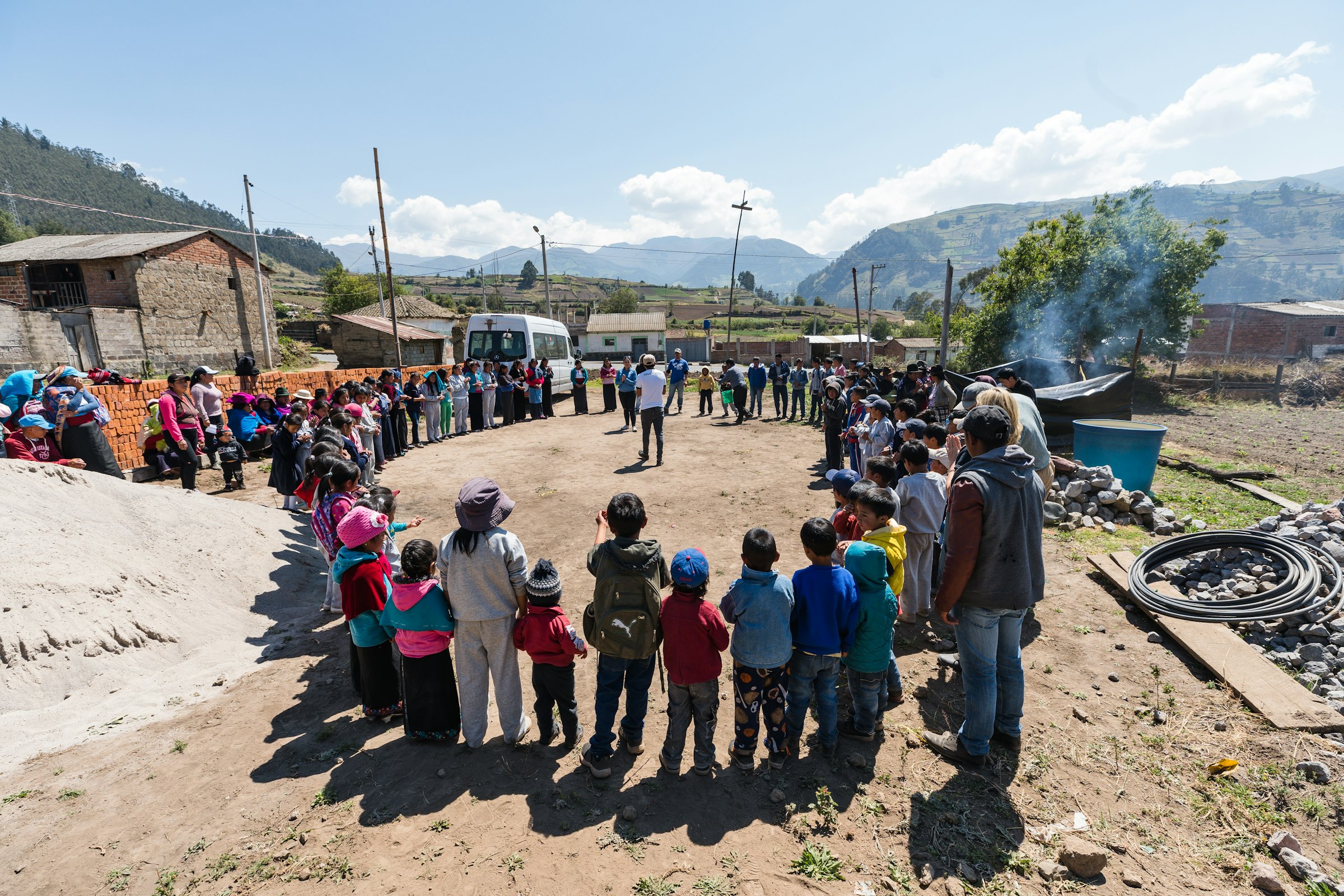 Community members gathered in a circle near a home in Alao, Ecuador