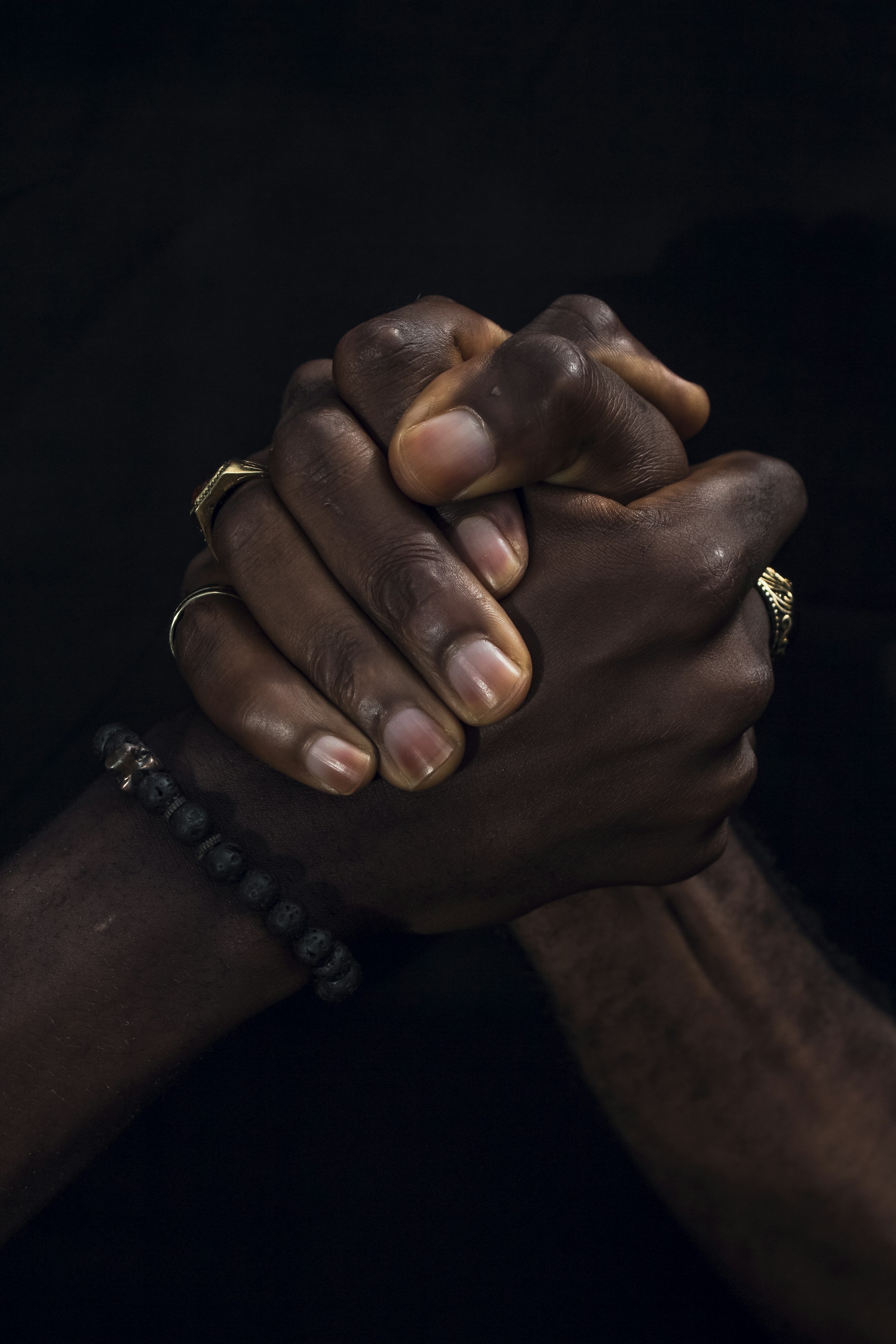 Close-up of two hands clasped together in a gesture of trust
