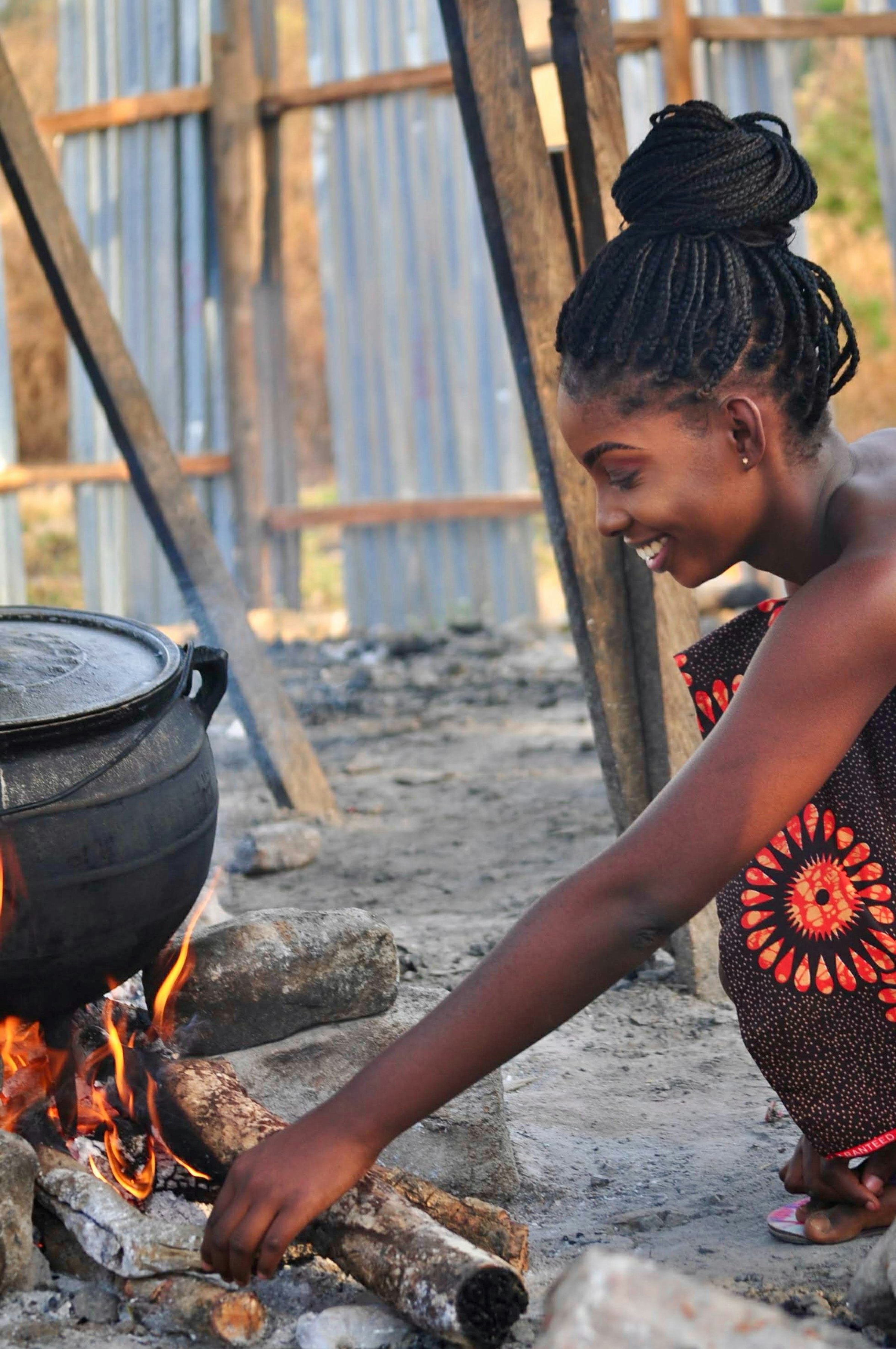 Woman cooking over a traditional three-stone fire in the Federal Capital Territory, Nigeria