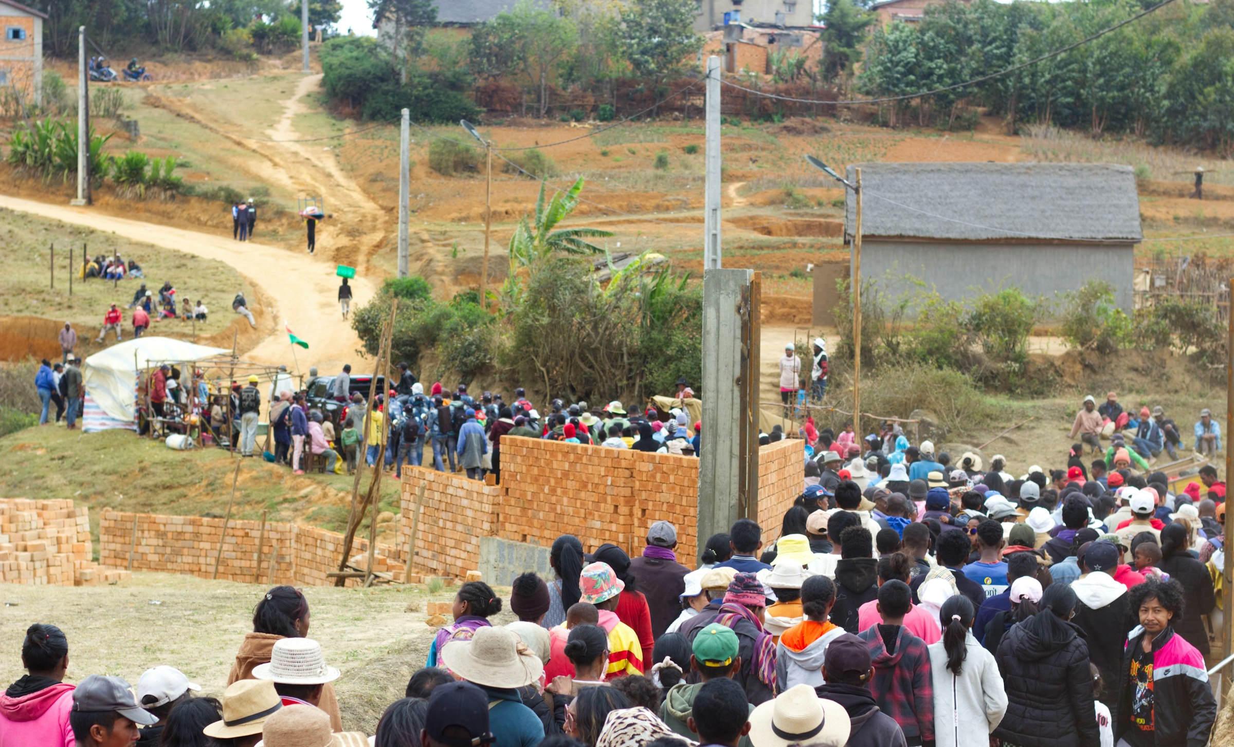Large crowd gathered in a rural village setting in Madagascar
