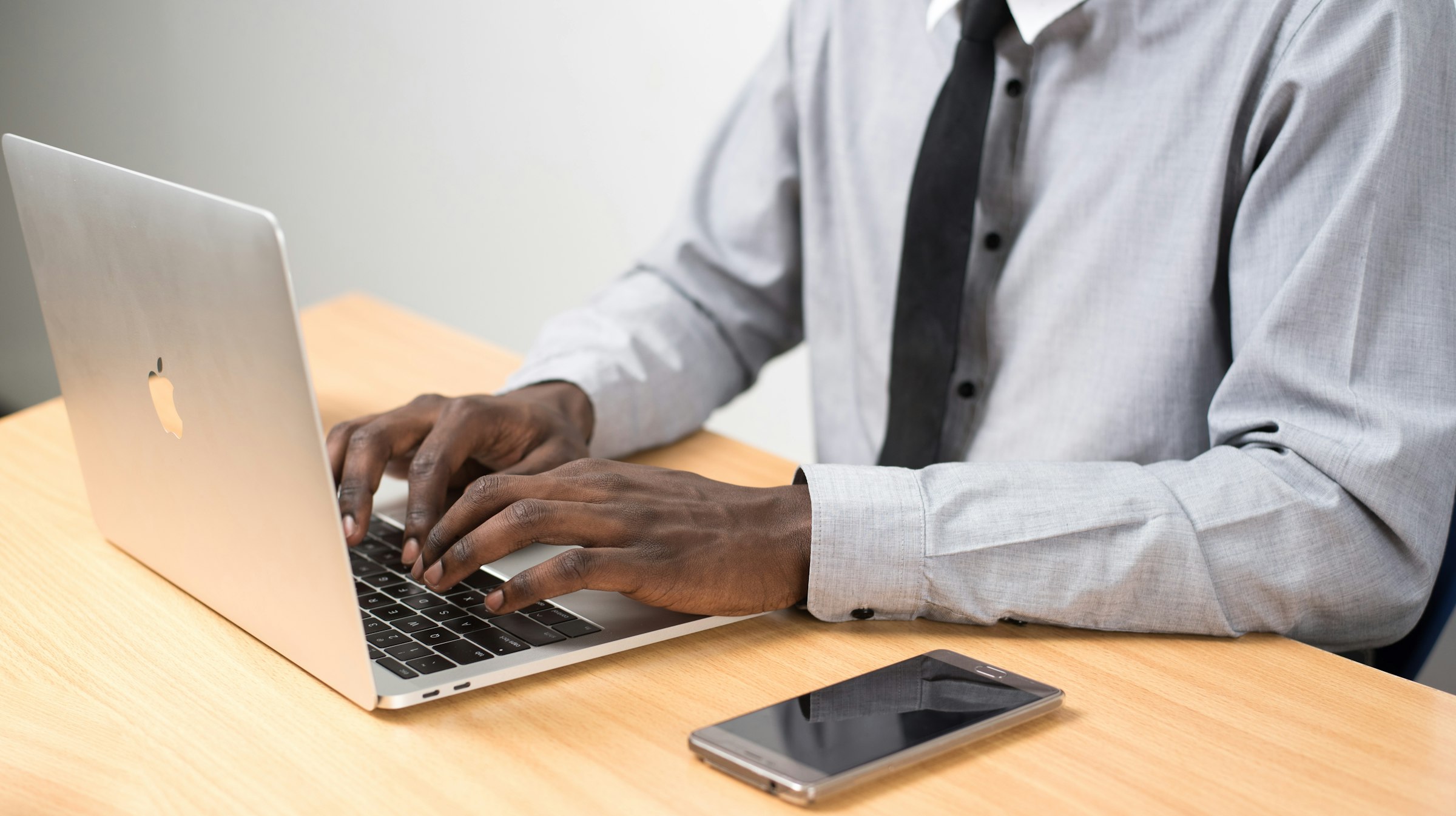 Office worker in Nairobi, Kenya entering data on a laptop